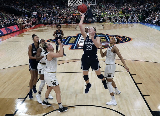 Connecticut's Katie Lou Samuelson drives against Notre Dame in the Final Four. Fans flocked to the women's NCAA Tournament, which had its highest attendance in over 15 years. [John Raoux/Associated Press]