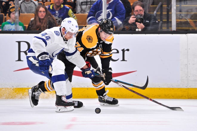 BOSTON, MA - APRIL 06: Boston Bruins Left Wing Jake Debrusk (74) battles Tampa Bay Lightning Defenceman Jan Rutta (44) for the loose puck. During the Boston Bruins game against the Tampa Bay Lightning on April 06, 2019 at TD Garden in Boston, MA. (Photo by Michael Tureski/Icon Sportswire) (Icon Sportswire via AP Images)
