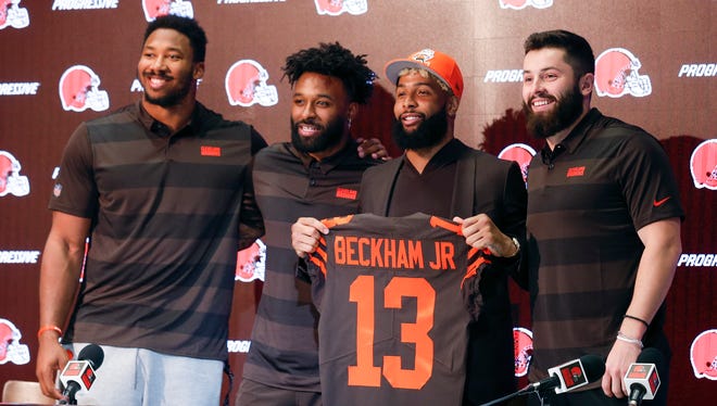 Cleveland Browns' Odell Beckham poses with his jersey along with Baker Mayfield, right, Myles Garrett, left, and Jarvis Landry during a news conference Monday, April 1, 2019, in Berea, Ohio. (AP Photo/Ron Schwane)