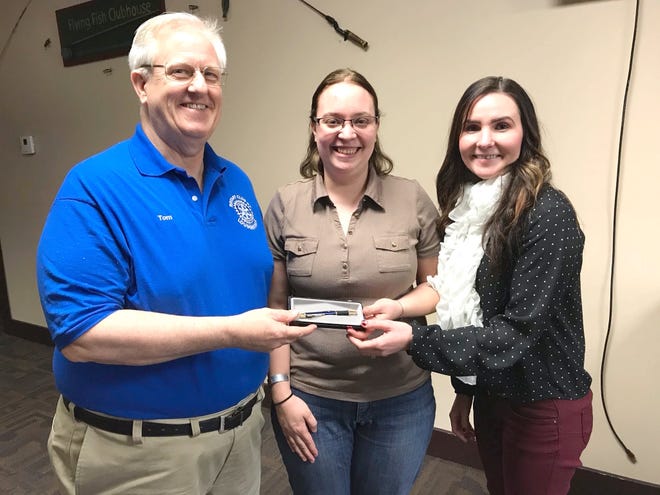 Loudonville Rotary Club President Tom Fish presents a Rotary speaker's pen to Brittany Sinnema Jackson, owner of Jackpot Pottery, which provides pottery products to the Alabaster Mouse in Loudonville. At right is Rotarian Logan Taylor, who arranged the program.