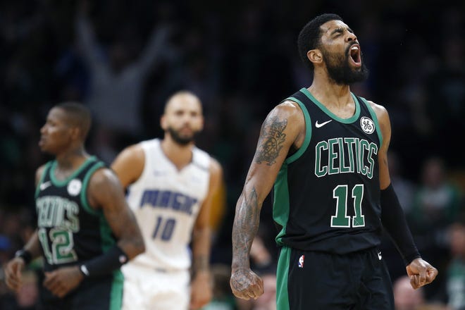Kyrie Irving celebrates as the Celtics rally against the Orlando Magic during the second half of Sunday's game at TD Garden. Boston will start the playoff at home against the Indiana Pacers. (AP Photo/Michael Dwyer)