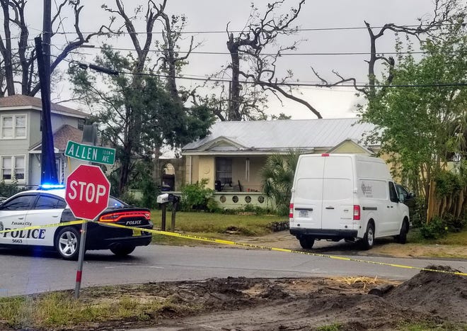 Crime scene tape stretches in front of two houses in the 100 block of Allen Avenue in the Cove on Friday morning. [JOSHUA BOUCHER/THE NEWS HERALD]