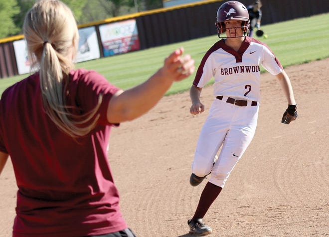 Brownwood head coach Jessica Lynn waves Annie Gillispie around third base to score the first run of the game in the top of the first inning of the No. 6 Lady Lions' 9-0 triumph over Godley Tuesday.
