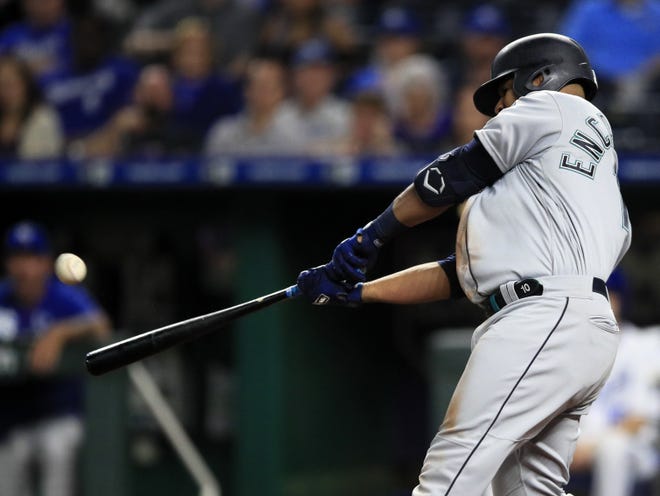 Seattle Mariners first baseman Edwin Encarnacion hits a three-run home run off Kansas City Royals relief pitcher Kevin McCarthy during the sixth inning of a baseball game at Kauffman Stadium in Kansas City on Monday. It was his second home run of the inning. [Orlin Wagner/The Associated Press]