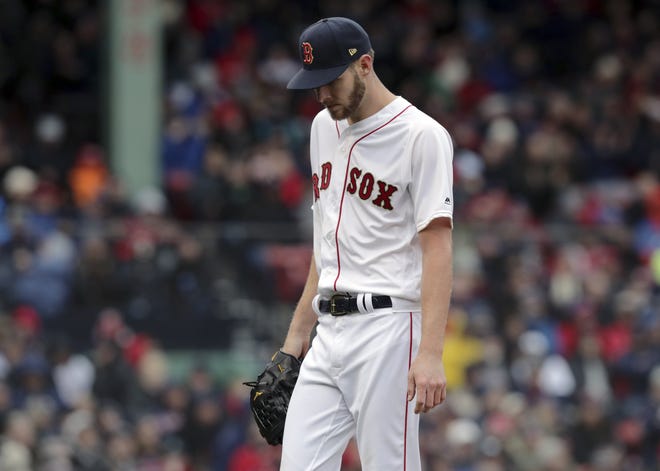 Red Sox starting pitcher Chris Sale walks off the mound after the top of the fourth inning of the home opener as the Blue Jays spoiled the pregame festivities with a 7-5 win over the Red Sox. [AP Photo/Charles Krupa]