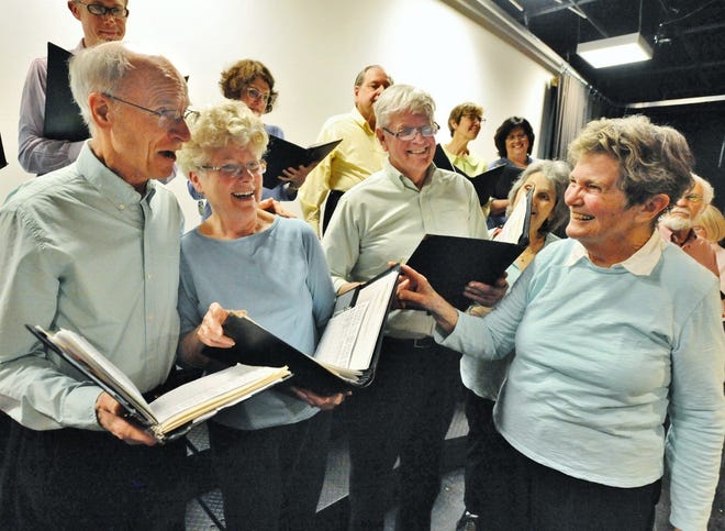 Unicorn Singers original members, from left, Ed Bartholomew of Hingham, Jeanne Scammell of Norwell, and Stephen Tooker of Scituate share a light moment with the group's founder, Margot Euler during the Unicorn Singers 40th anniversary concert rehearsal at Linden Ponds in Hingham on Monday, April 1, 2019. Tom Gorman/For The Patriot Ledger