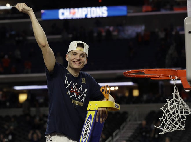 Virginia's Kyle Guy celebrates after defeating Texas Tech 85-77 in overtime in the college basketball National Championship game on Monday night in Minneapolis. [AP PHOTO/DAVID J. PHILLIP]