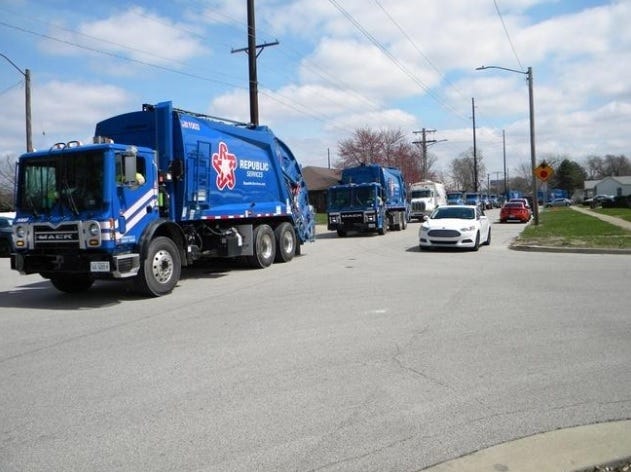 The funeral procession for Ronnie Davis included several trash trucks from his employer, Republic Services. [DEAN OLSEN/SPRINGFIELD STATE JOURNAL-REGISTER]