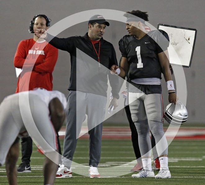 In this file photo Ohio State Buckeyes quarterback Justin Fields (1) and Ohio State Buckeyes head coach Ryan Day talk during practice at Woody Hayes Athletic Center on March 23, 2019. The Ohio State football program invited current students to attend a student appreciation day practice, the seventh time in the last eight years that a practice has been opened up to honor and thank the students on campus.