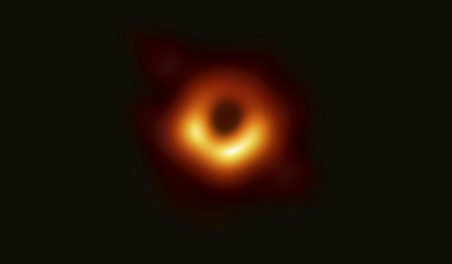 This image released Wednesday by Event Horizon Telescope shows a black hole. Scientists revealed the first image ever made of a black hole after assembling data gathered by a network of radio telescopes around the world. (Event Horizon Telescope Collaboration/Maunakea Observatories via AP)