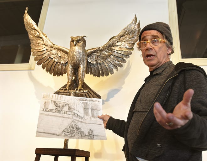 Seen with his stainless steel sculpture of a great horned owl seen behind him, Barney Zeitz holds a sketch of the sculpture he has planned for Fall River Government Center, at the Narrows Center for The Arts Tuesday April, 9, 2019, in Fall River, Massachusetts. [Herald News Photo | Jack Foley]