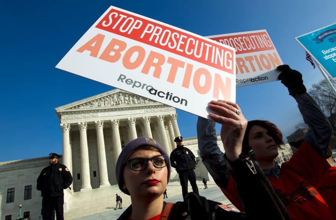 FILE - In this Jan. 18, 2019, file photo, abortion rights activists protest outside of the U.S. Supreme Court, during the March for Life in Washington. Emboldened by the new conservative majority on the Supreme Court, anti-abortion lawmakers and activists in numerous states are pushing near-total bans on the procedure in a deliberate frontal attack on Roe v. Wade. (AP Photo/Jose Luis Magana, File)