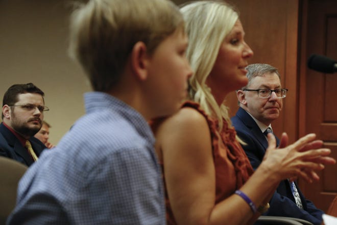 Dr. Edward Fox, a neurologist specializing in Multiple Sclerosis, listens to Leana Dando as she testifies to a Texas House sub-committee about the benefits that CBD oil have had for her son Freeman Dando, 13. Dando has intractable epilepsy. [JAMES GREGG/AMERICAN-STATESMAN]