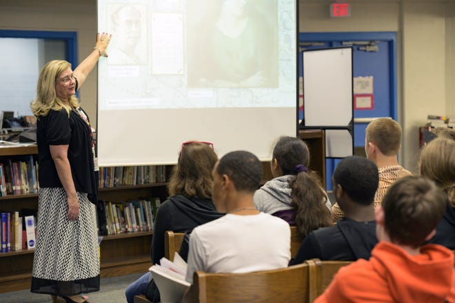 Sylvia Tarquine, an eighth-grade language arts teacher at Tavares Middle School, holds a presentation on the Holocaust for students. [Cindy Sharp/Correspondent]