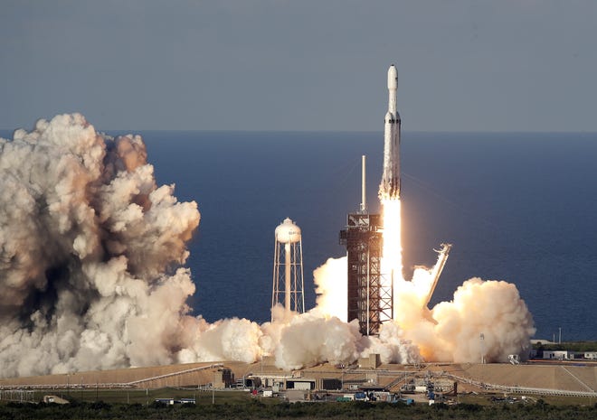 A SpaceX Falcon Heavy rocket carrying a communication satellite lifts off from pad 39A at the Kennedy Space Center in Cape Canaveral Thursday. [JOHN RAOUX/THE ASSOCIATED PRESS]