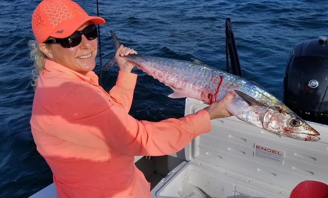 Karen Betz of Tampa shows off a 12-pound king mackerel she caught on a free lined, scaled sardine about seven miles offshore of St. Petersburg while fishing with her husband Capt. Steve Betz of FLATSANDBAY.COM Fishing of Tampa this past weekend. (Provided by: Capt. Steve Betz)