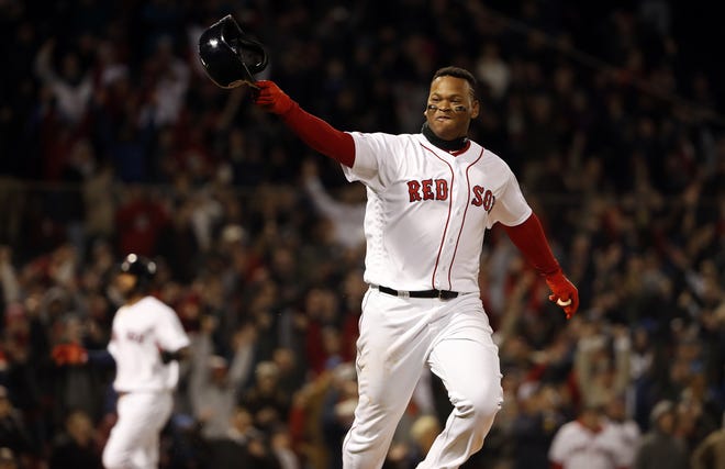 Boston Red Sox's Rafael Devers points to the team's dugout after hitting a walk-off single against the Toronto Blue Jays during the ninth inning of a baseball game Thursday, April 11, 2019, at Fenway Park in Boston. Boston won 7-6. (AP Photo/Winslow Townson)
