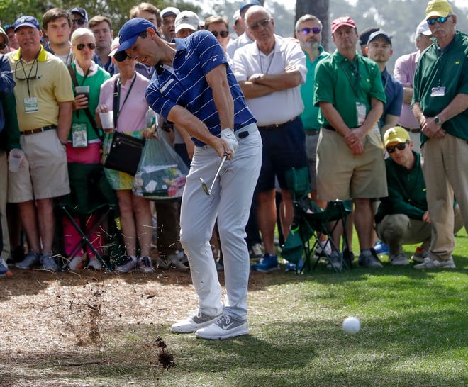 Rory McIlroy, of Northern Ireland, hits from the rough on the first hole during the first round for the Masters golf tournament Thursday, April 11, 2019, in Augusta, Ga. (AP Photo/Marcio Jose Sanchez)