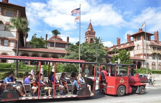 A sightseeing train carries visitors to St. Augustine past Flagler College. Visit Florida, the stateþÄôs marketing agency, is in the middle of a budget battle between the Senate and the House, and the state's agreement with the organization is set to expire on Oct. 1 if not reauthorized by lawmakers. Local experts say attracting tourists to St. Johns County without the agency's help could be challenging. [PETER WILLOTT/THE RECORD]