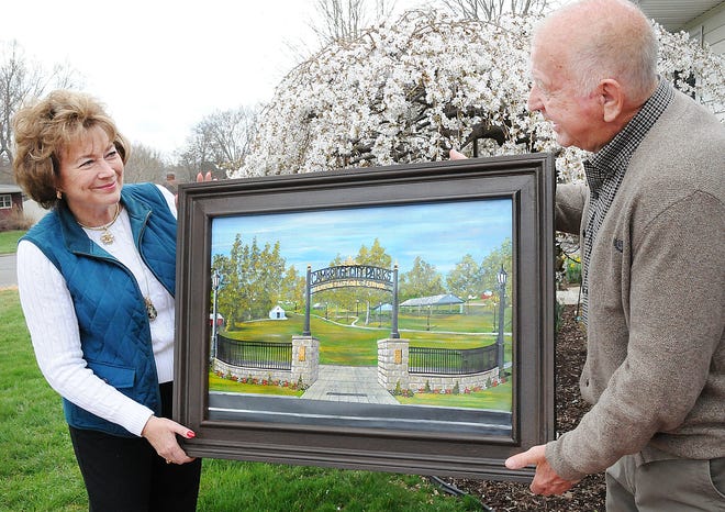Carol Wilcox-Jones, director of the annual Salt Fork Arts and Crafts Festival, and Bob Jennings, hold a painting done by Jennings of the proposed new entry for the festival into Cambridge City Park. Bob is also a committee member for the festival.
