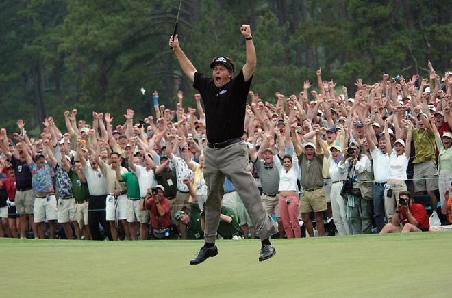 Phil Mickelson celebrates winning the 2004 Masters. [DAVE MARTIN/ASSOCIATED PRESS]