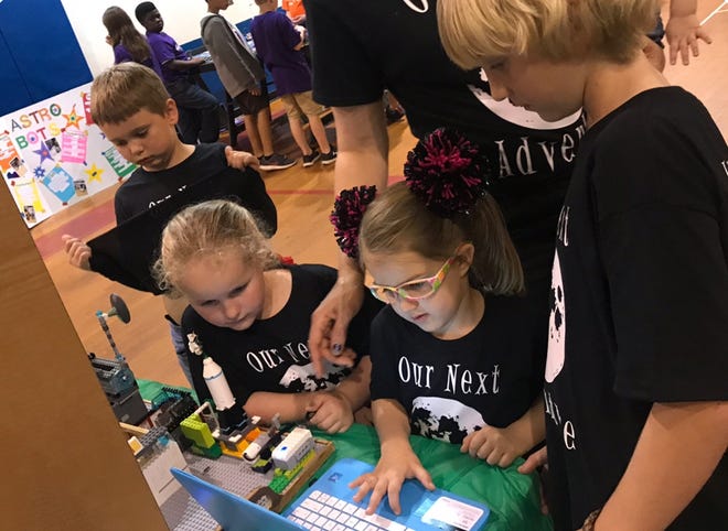 Members of the Paxton Lunar Cats Lego League Junior team showcase their project at a local event. [CONTRIBUTED PHOTO]