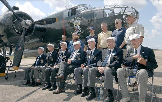 The then-surviving members of the Doolittle Raiders, seated, pose in 2008 with a B-25 bomber used in a local re-enactment of the pivotal World War II bombing raid over Japan. Descendants of the Doolittle Raiders will be at the Air Force Armament Museum next week for a toast to the Raiders. [DAILY NEWS/FILE PHOTO]