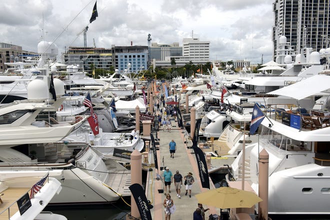 Visitors walk among the yachts at this year's Palm Beach International Boat Show. The event saw attendance jump more than 6.7 percent over last year, organizers said this week. [MELANIE BELL/palmbeachdailynews.com]