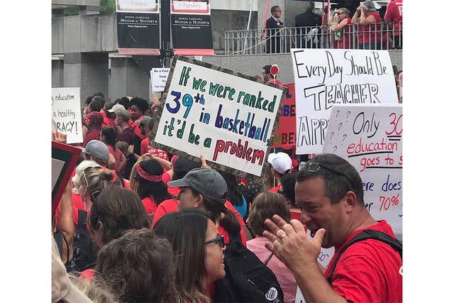 SIGN OF SUPPORT — Philip Homiller, with Asheboro High School, took this photo at the May 2018 Rally for Respect in Raleigh. He said those attending seemed more focused on overall funding and per student funding, rather than teacher pay. (Contributed)