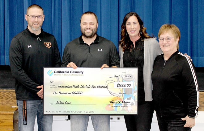 A $1,000 Athletics Grant from California Casualty is helping keep Newcomerstown Middle School football players safer. The funds will go toward purchasing better fitting helmets. Taking part in the presentation are, l to r, Newcomerstown Middle School Principal Jason Peoples, Coach and applicant Ryan Henderson, California Casualty’s Beth Nagy, and Janel Travis President of the Newcomerstown Teachers Association.