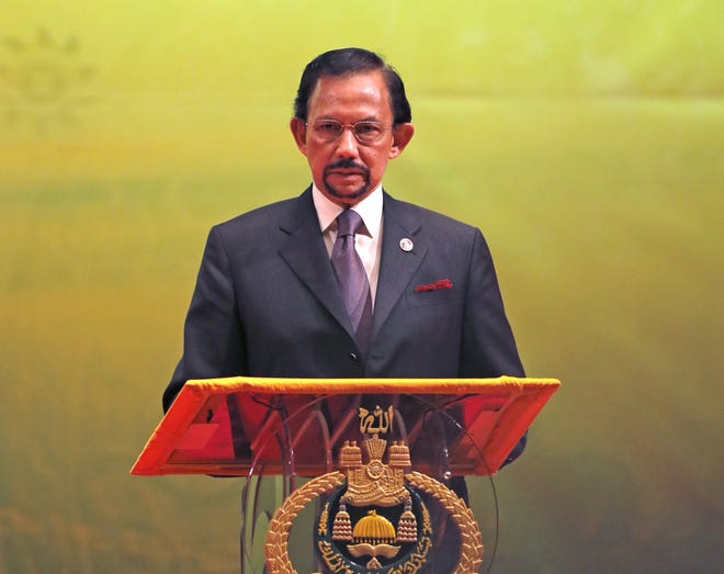 In this Oct. 10, 2013, photo, Brunei's Sultan Hassanal Bolkiah speaks during the closing ceremony and handover of the ASEAN Chairmanship to Myanmar in Bandar Seri Begawan. The sultan announced to implement Islamic criminal laws that punishes gay sex by stoning offenders to death. The legal change in the tiny, oil-rich monarchy, which also includes amputation for theft, came into force Wednesday, April 3, 2019. [AP Photo/Vincent Thian]