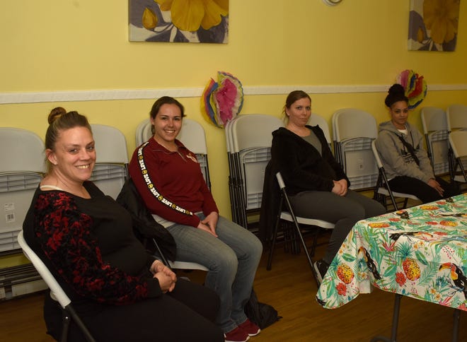 Jillian Poirier, Leita Burbak, Kayla Malaguti and Shenik Fonseca all trying ear acupuncture, a new tool that some claim could help end addiction, in Fall River on April 12, 2019. [Herald News Photo | Dave Souza]