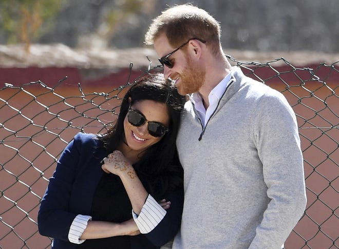 In this Sunday, Feb. 24, 2019 file photo, Britain's Prince Harry and Meghan, Duchess of Sussex, watch children playing football at a school in the town of Asni, in the Atlas mountains, Morocco. Prince Harry and Meghan, the Duchess of Sussex, may be keeping plans about their impending baby under wraps, but that hasn't stopped everyone in Britain from trying to guess what they're having - or laying a wager on the name they've chosen for their first child. [Facundo Arrizabalaga/Pool via AP, File]