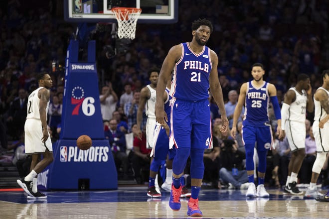 The Sixers' Joel Embiid looks on during the second half of Saturday's Game 1 against the Nets in Philadelphia. The Nets won 111-102. The Sixers weren't the only home team to struggle over the weekend. In fact, only the Golden State Warriors held serve against lower seeded teams. [CHRIS SZAGOLA / THE ASSOCIATED PRESS]