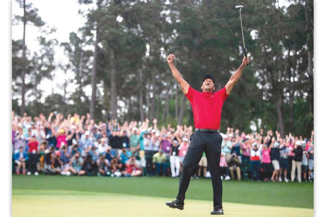 ANOTHER WIN FOR THE AGES — Tiger Woods celebrates on Augusta National’s 18th hole after winning his fifth Masters Tournament, and first since 2005.