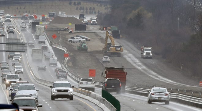 In a Friday, April 12, 2019 photo, Interstate Highway 75 construction continues in Troy, Mich. After passing waves of tax cuts in recent years, some Republican-dominated states have decided it's time to make a big exception, calling for tax increases to fix roads crumbling from years of low funding and deferred maintenance. (AP Photo/Carlos Osorio)