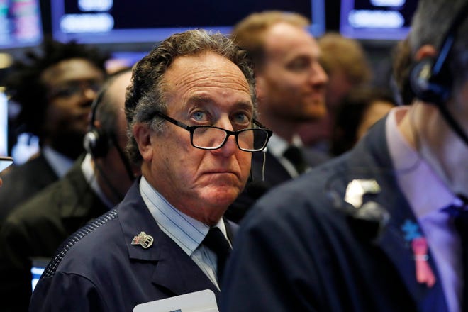 Trader Steven Kaplan works on the floor of the New York Stock Exchange on Friday. U.S. stock indexes edged lower on Monday, pulled down by sinking bank stocks, and the S&P 500 fell for just the third time in the last three weeks. [AP Photo / Richard Drew]