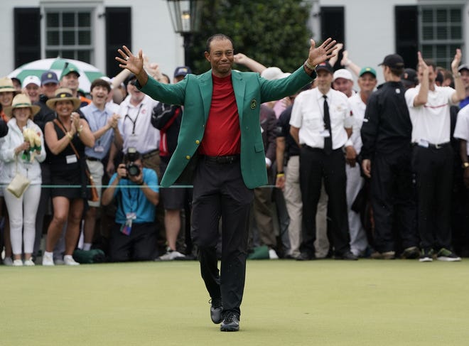 Tiger Woods celebrates after he won the Masters on Sunday in Augusta. [DAVID J. PHILLIP/THE ASSOCIATED PRESS]