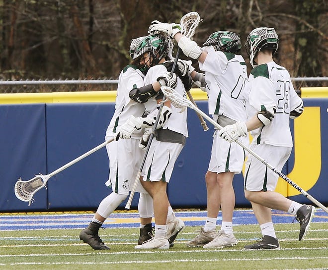 Dartmouth's Angelo Nicolosi, second from left, is congratulated by teammates after Nicolosi's overtime goal gave the Indians a 7-6 victory over Apponequet at UMass Dartmouth's Cressy Field. [MIKE VALERI/THE STANDARD-TIMES/SCMG]