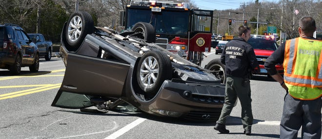 Officials investigate a two-vehicle crash Tuesday in the westbound lane of Route 28 by the Centerville Shopping Center. [Steve Heaslip/Cape Cod Times]