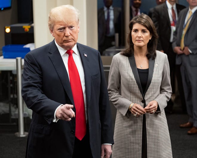 President Donald Trump addresses members of the news media as he arrives with Nikki Haley, the U.S. ambassador to the UN, during the 73rd session of the United Nations General Assembly, at U.N. headquarters, Tuesday, Sept. 25, 2018. (AP Photo/Craig Ruttle)