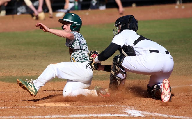 Michael Green slides past Jefferson Forest catcher Ben Holley during their Easter tournament game at Shelby High School on Tuesday. [Brittany Randolph/The Star]