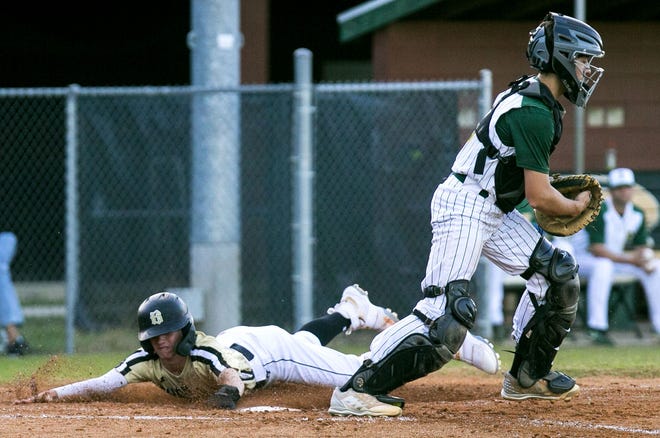 Buchholz' Cole Howard (4) slides into home for a run in the top of the third inning against Forest High School on Tuesday at Forest. Forest lost to Buchholz 8-3. [Cyndi Chambers/Correspondent]