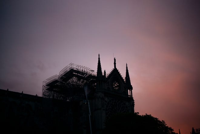 The Notre Dame cathedral is seen on sunrise after the fire in Paris, Tuesday, April 16, 2019. A catastrophic fire engulfed the upper reaches of Paris' soaring Notre Dame Cathedral as it was undergoing renovations Monday, threatening one of the greatest architectural treasures of the Western world as tourists and Parisians looked on aghast from the streets below. (AP Photo/Kamil Zihnioglu)