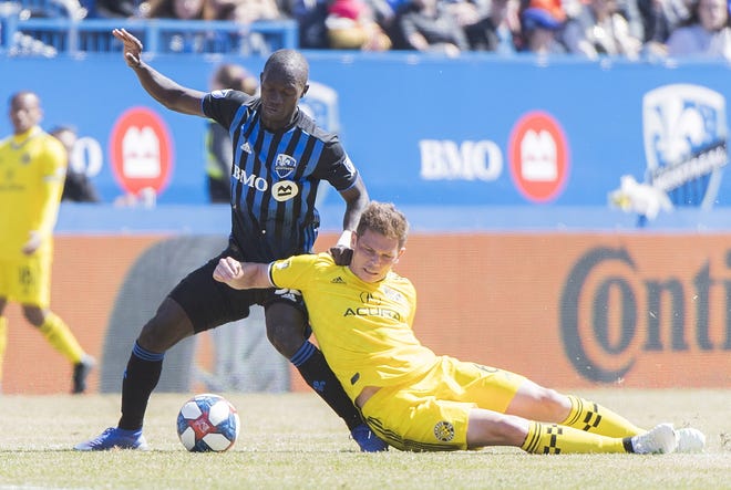 The Impact's Micheal Azira, left, battles for the ball with the Crew's Wil Trapp during Saturday's game in Montreal. The Crew had plenty of scoring chances but lost 1-0. [Graham Hughes/The Canadian Press]