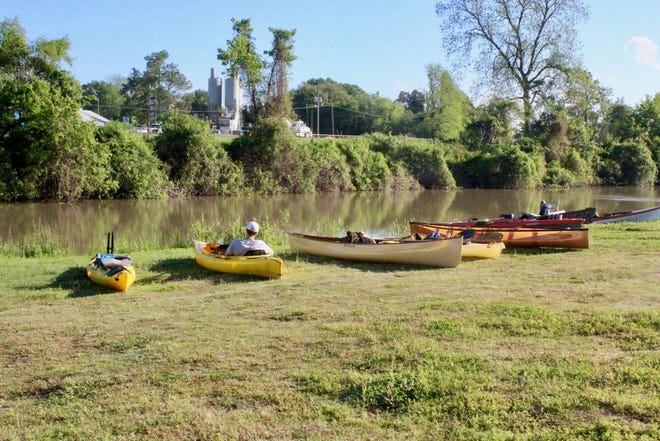 Kayaker resting in his kayak next to empty ones.
