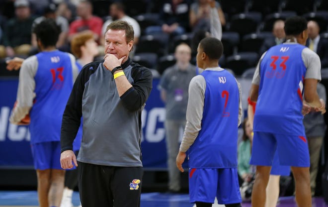 Kansas basketball coach Bill Self, left, has shot down rumors that he could depart for an NBA job this offseason. “I’ll be the coach here at Kansas next year,” he said Tuesday night at the team’s season-ending banquet. [File photograph/Chris Neal, The Capital-Journal]