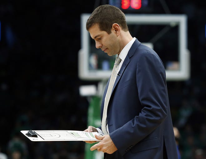 Boston Celtics head coach Brad Stevens looks over his notes during a timeout in the second quarter of Sunday's Game 1 of a first-round series against the Indiana Pacers at TD Garden. (AP File Photo/Winslow Townson)