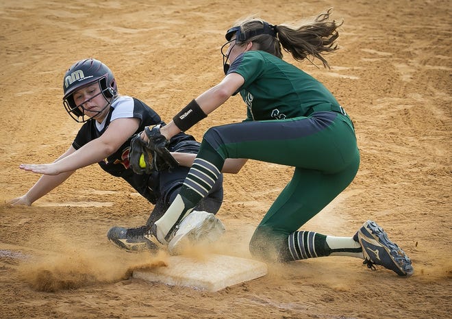 North Marion's (10) Kaylee Mcneill is tagged out at third base in the bottom of the second inning by Villages (6) Cameron Norton. The North Marion Colts defeated the Villages 9-1 Wednesday night at North Marion High School. [Doug Engle/Staff photographer]