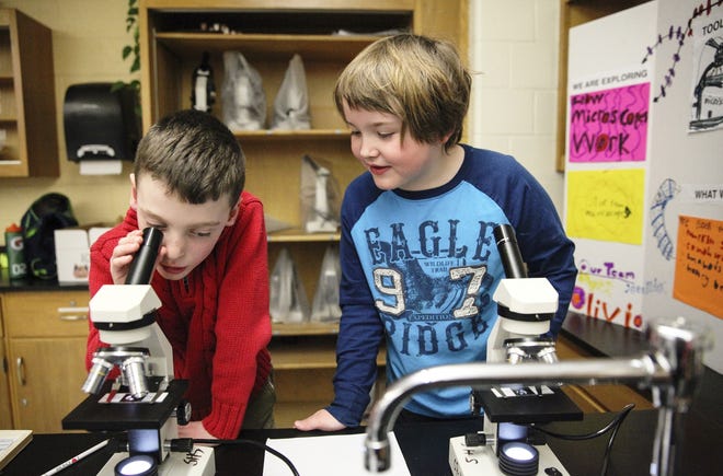 Patrick McCarthy and Brady Jones experiment with microscopes at the 2015 Science Spectacular in Scituate. (Wicked Local file photo)